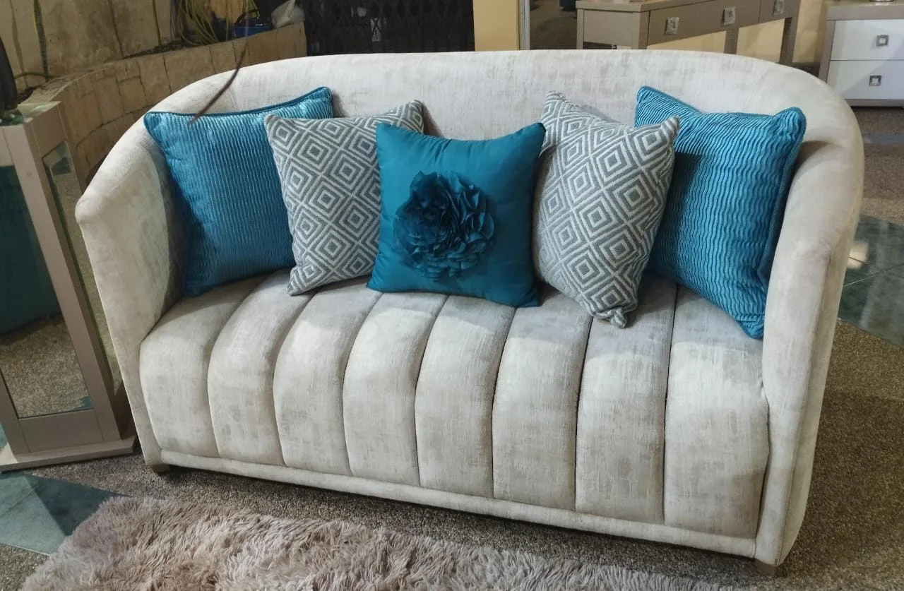 Sala a medida — loveseat canalado gris claro con cojines teal